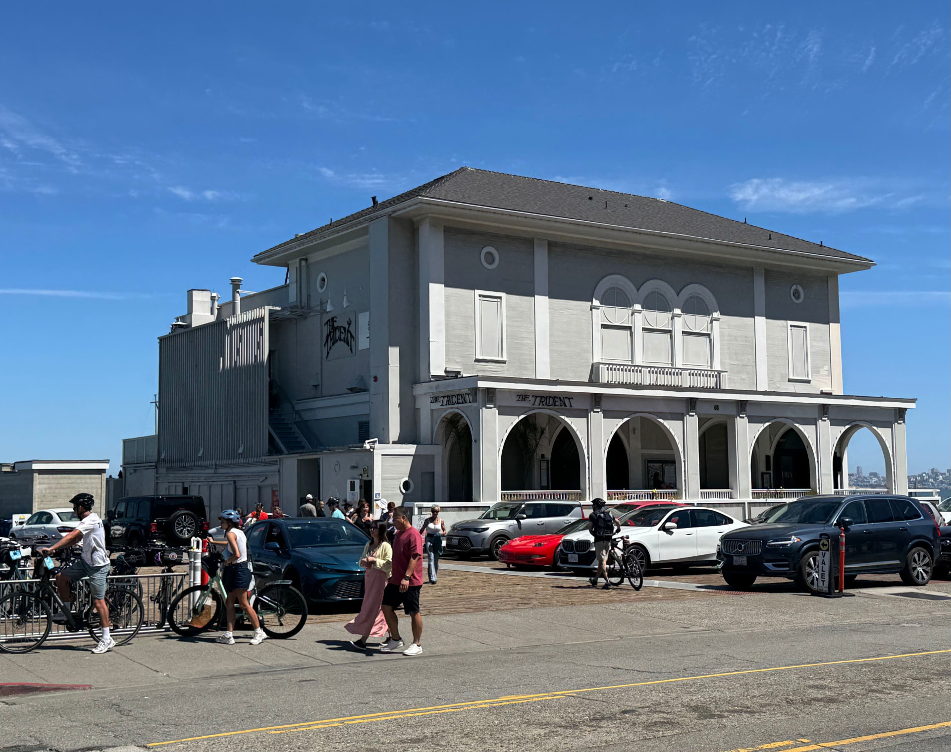 562 Bridgeway in Sausalito on a clear afternoon, THE TRIDENT lettering over the white arcade arches and ERIA lettering on the glass two arches down