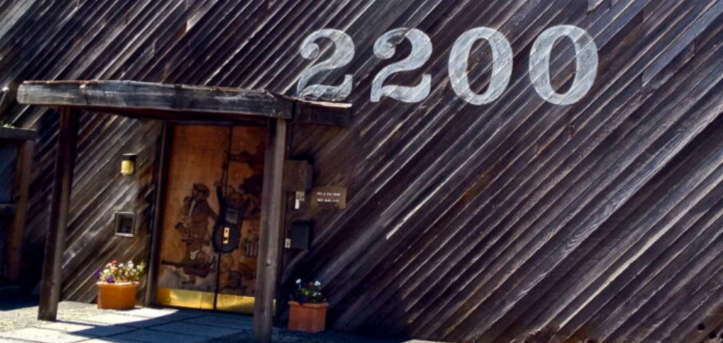 The diagonal redwood siding and hand-painted '2200' address at 2200 Bridgeway, Sausalito.