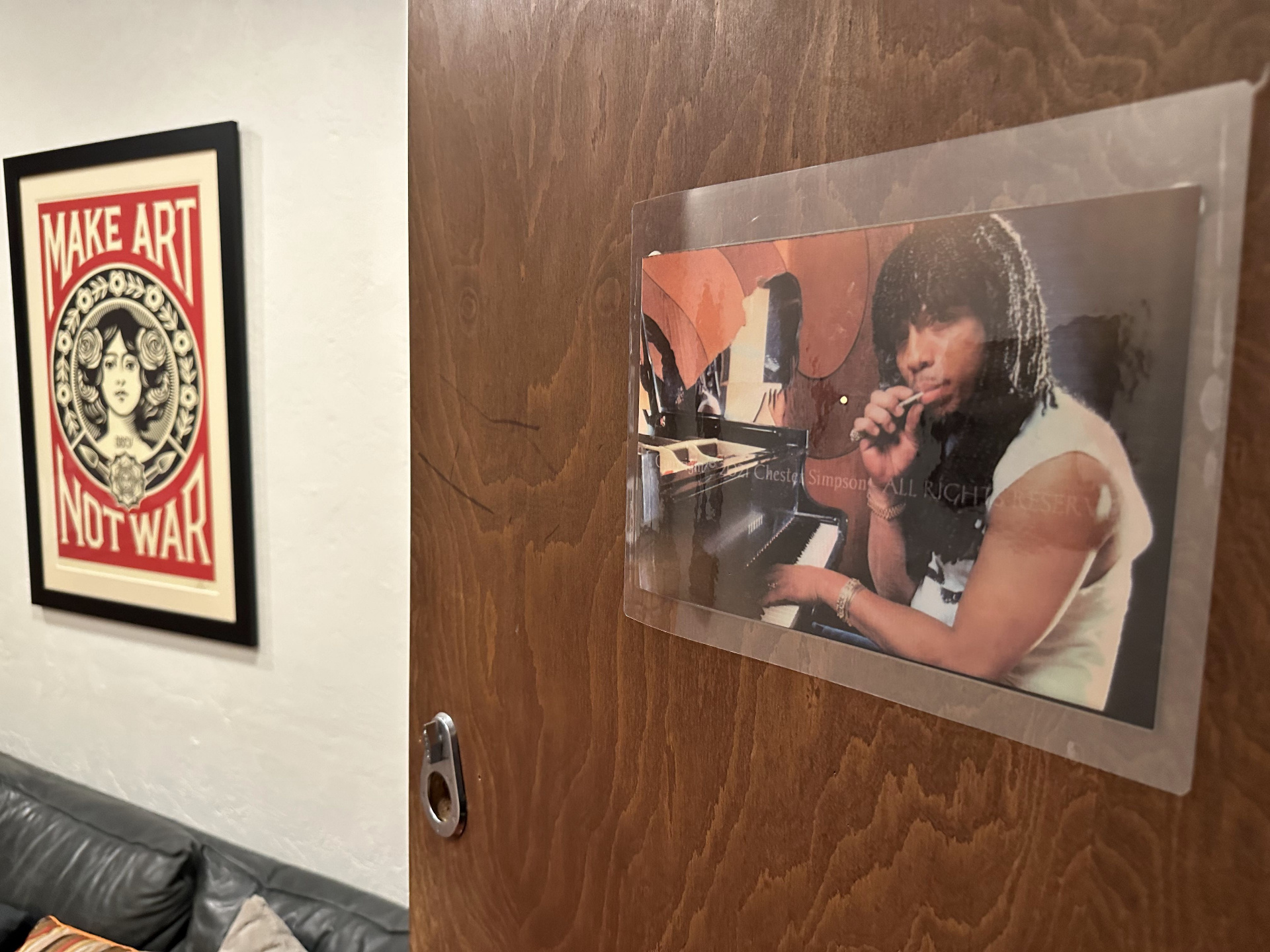 A photograph of Rick James at a piano, mounted on the wooden door to his former conference-room living quarters at the studio.